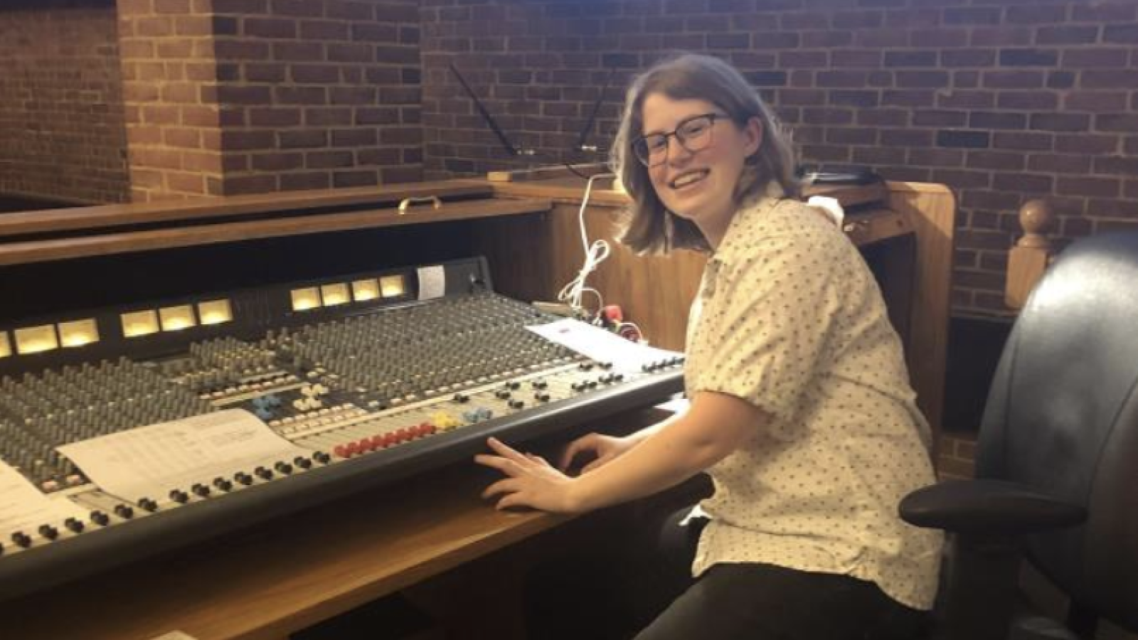 Emily at a sound board