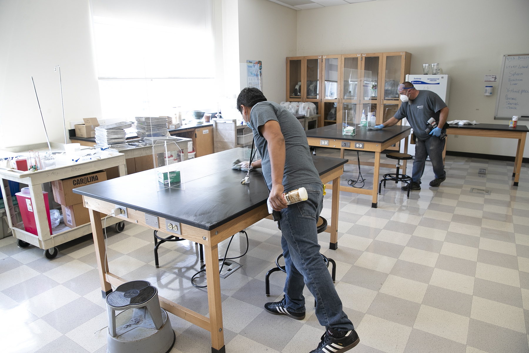 Facilities staff cleaning a classroom