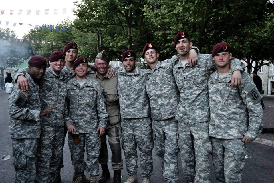 Joshua Redlich standing with his Army colleagues
