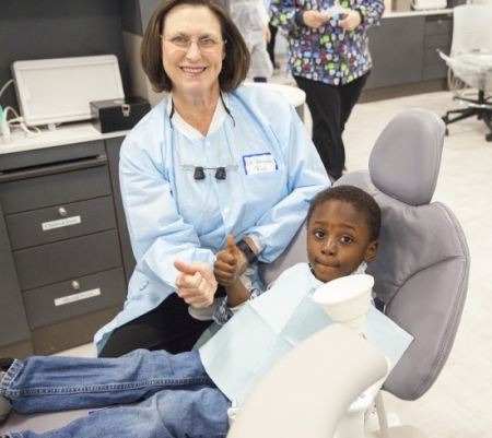 dentist with kid in dentist chair