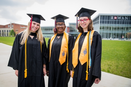 three female students in graduation garb