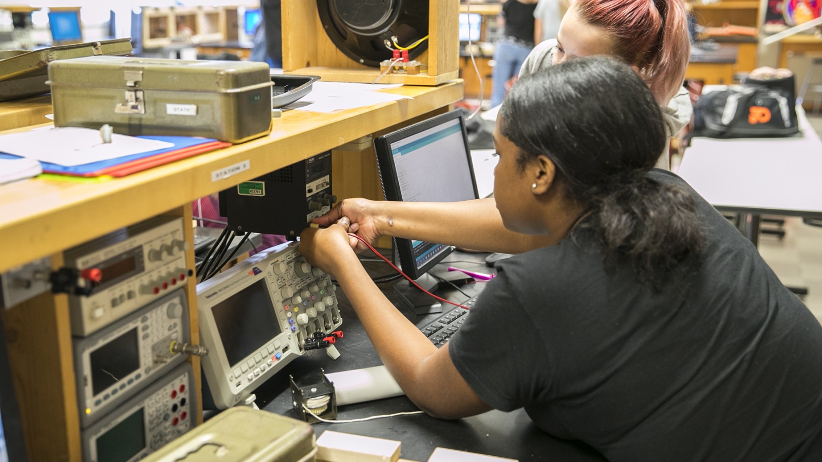 student working on electronic equipment