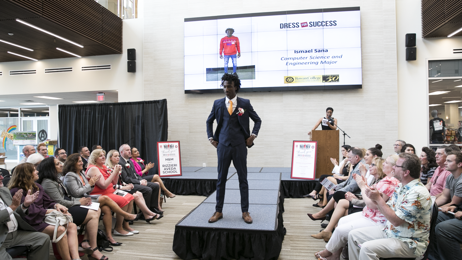 A photo of a student posing in their suit during the 2019 Dress for Success event. 
