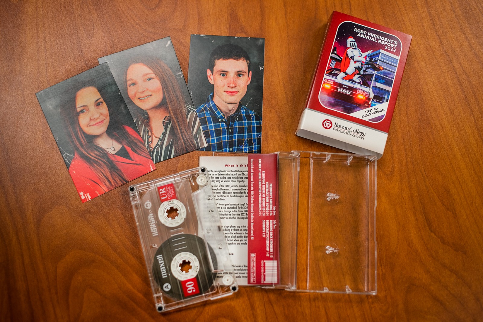 Image of the tape, and insert cards of three student graduates.