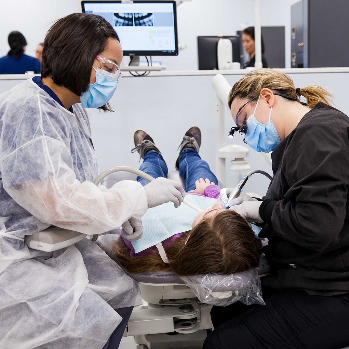 Dental hygiene students providing care to a child