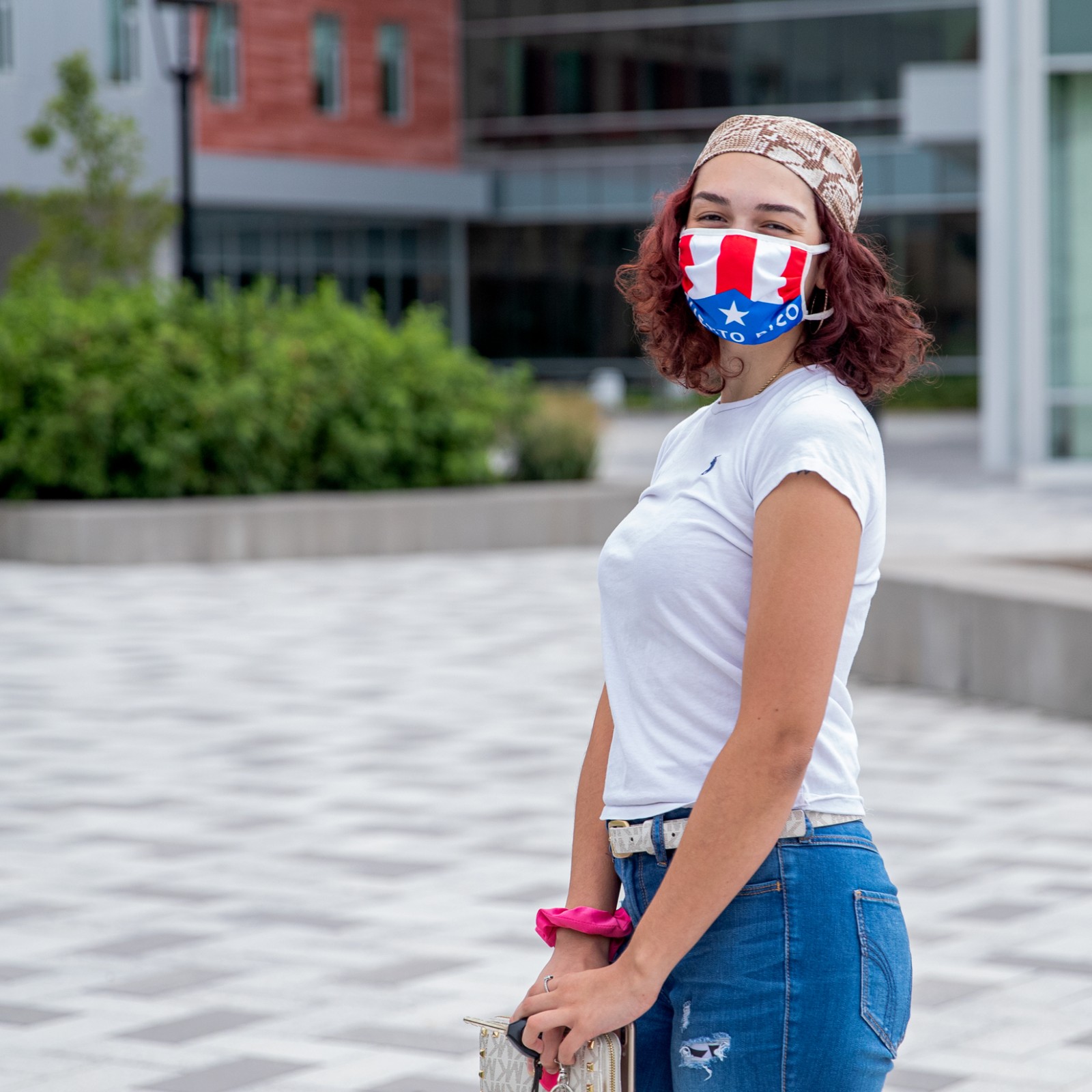 female student standing in front of Student Success Center wearing a mask