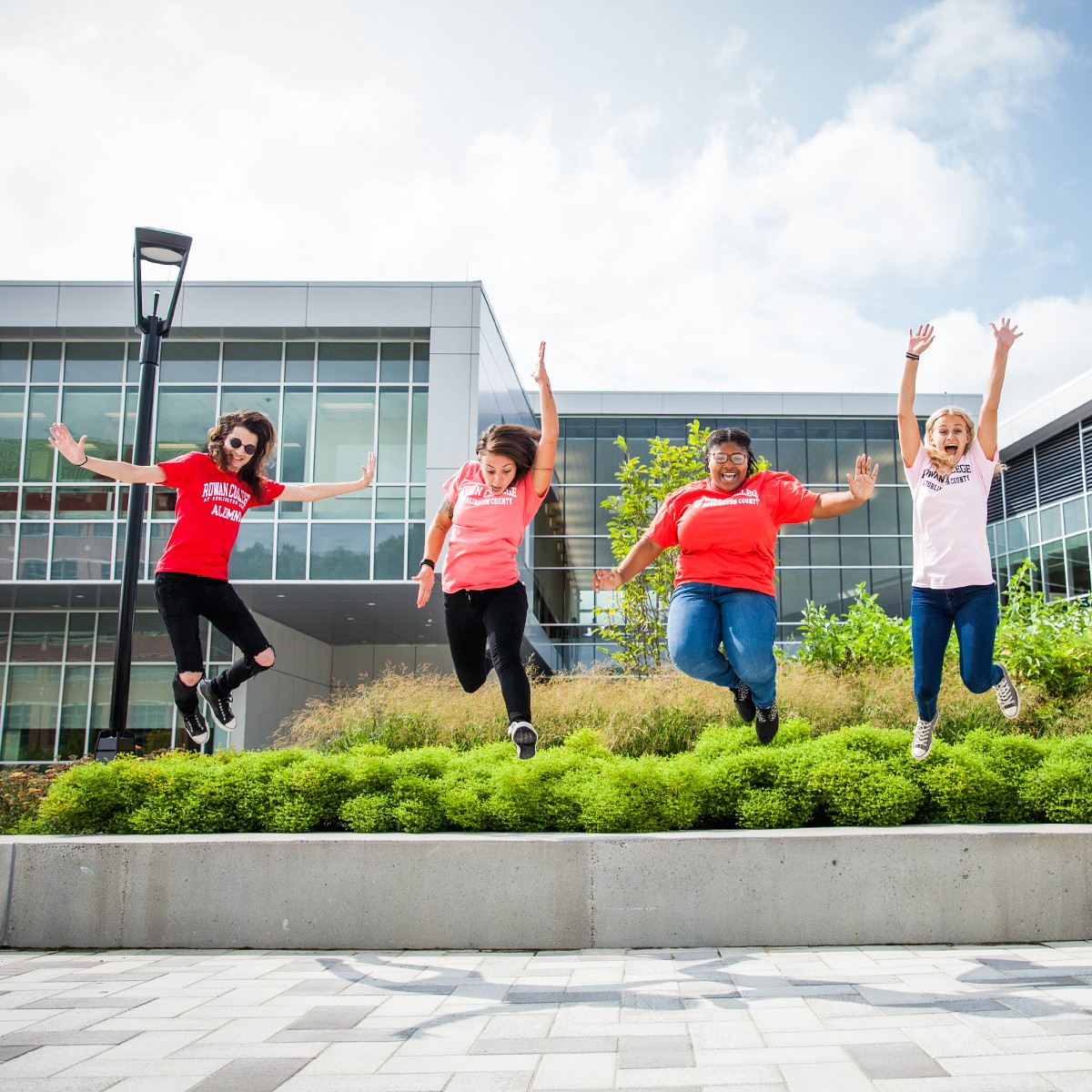 students jumping in front of the student success center 