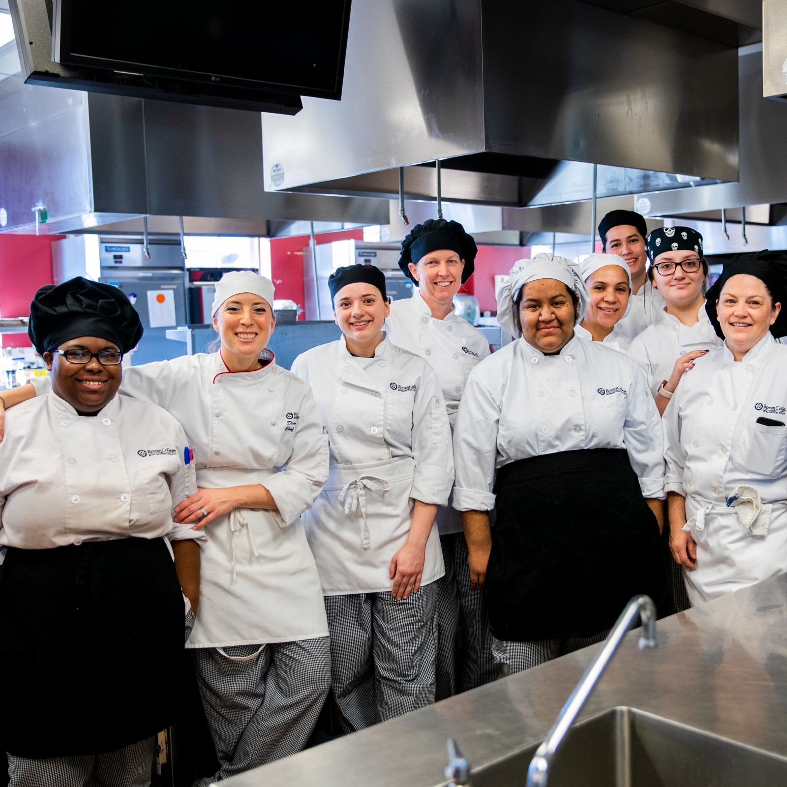 Culinary students standing side-by-side in RCBC culinary kitchen